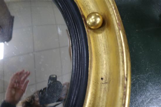 A Regency convex mirror with acanthus and eagle surmount, H.3ft.